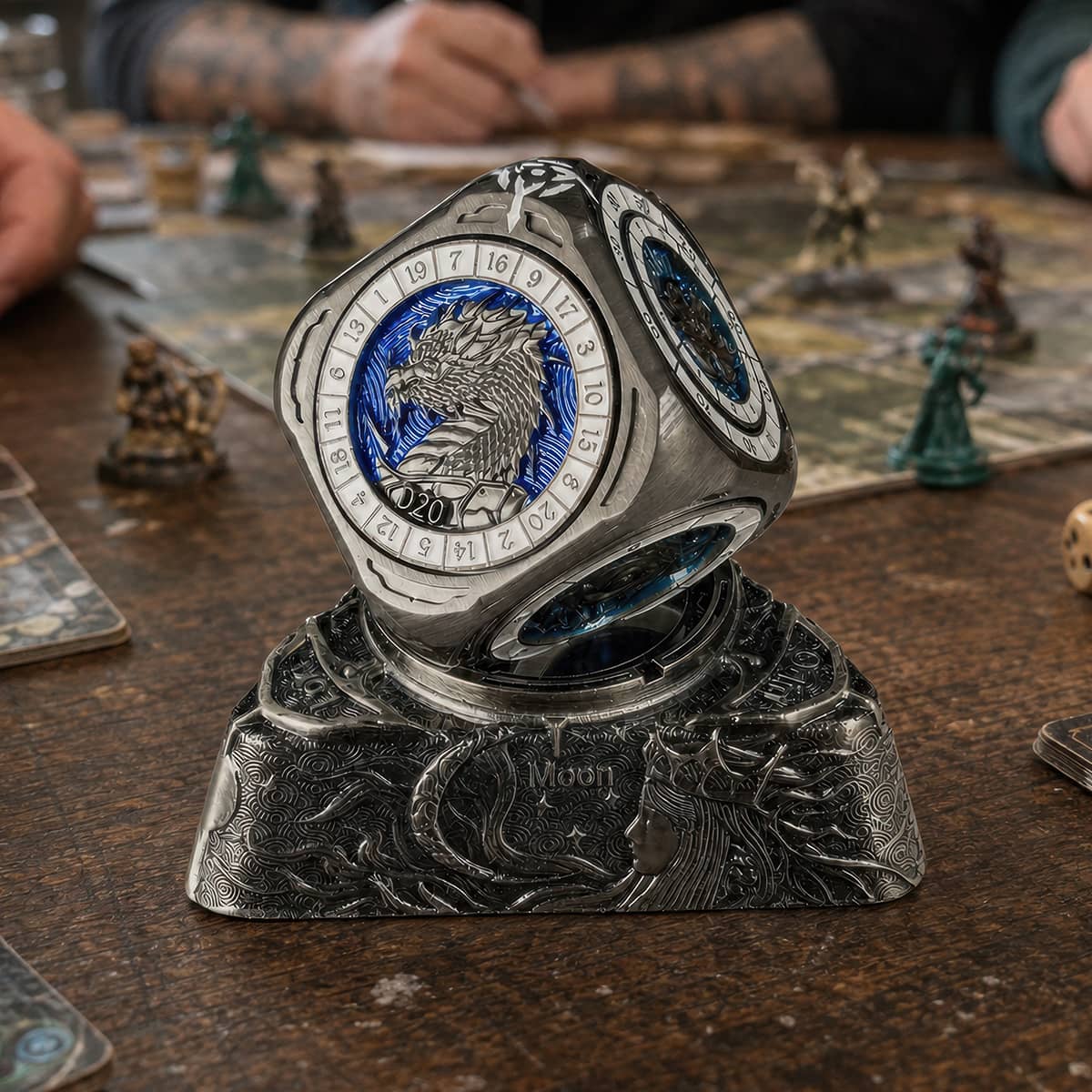 Silver and blue 7-in-1 spinner dice on its dragon base during a tabletop RPG session.