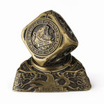 Antique gold 7-in-1 metal RPG spinner dice on an earth-themed dragon base.