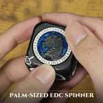 Hand turning a palm-sized silver and blue 7-in-1 RPG spinner dice.