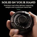 Hand holding the black alloy D20 decision roulette to show its compact, weighty build.