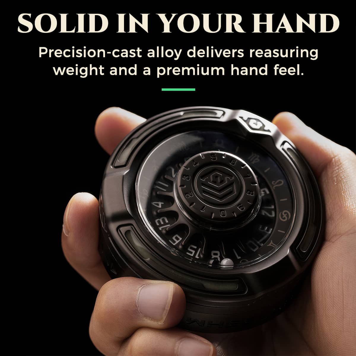 Hand holding the black alloy D20 decision roulette to show its compact, weighty build.