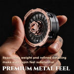 Rose gold and black metal D20 decision spinner held in one hand with its premium finish visible.