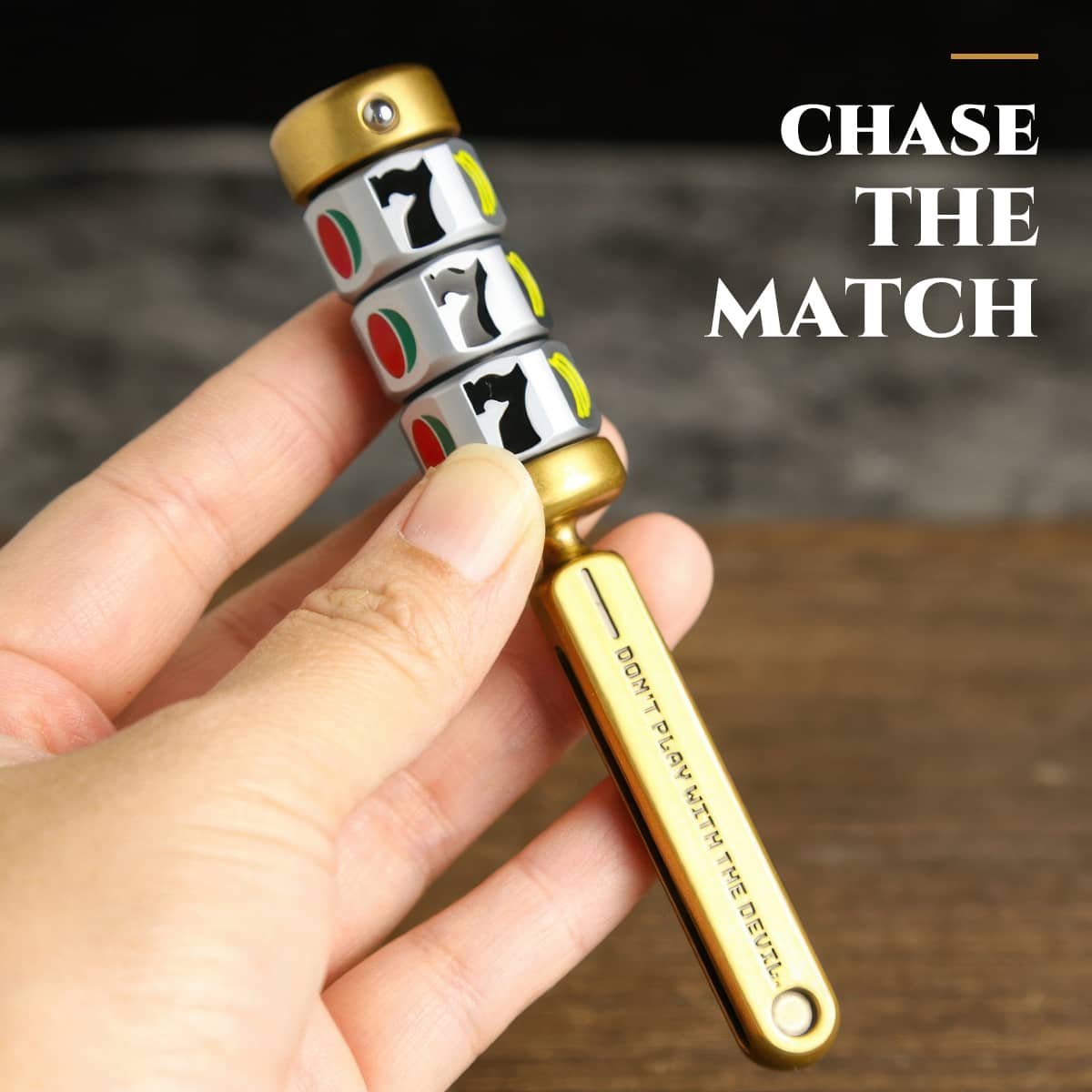 Hand holding the gold magnetic fruit reel spinner while matching fruit symbols.
