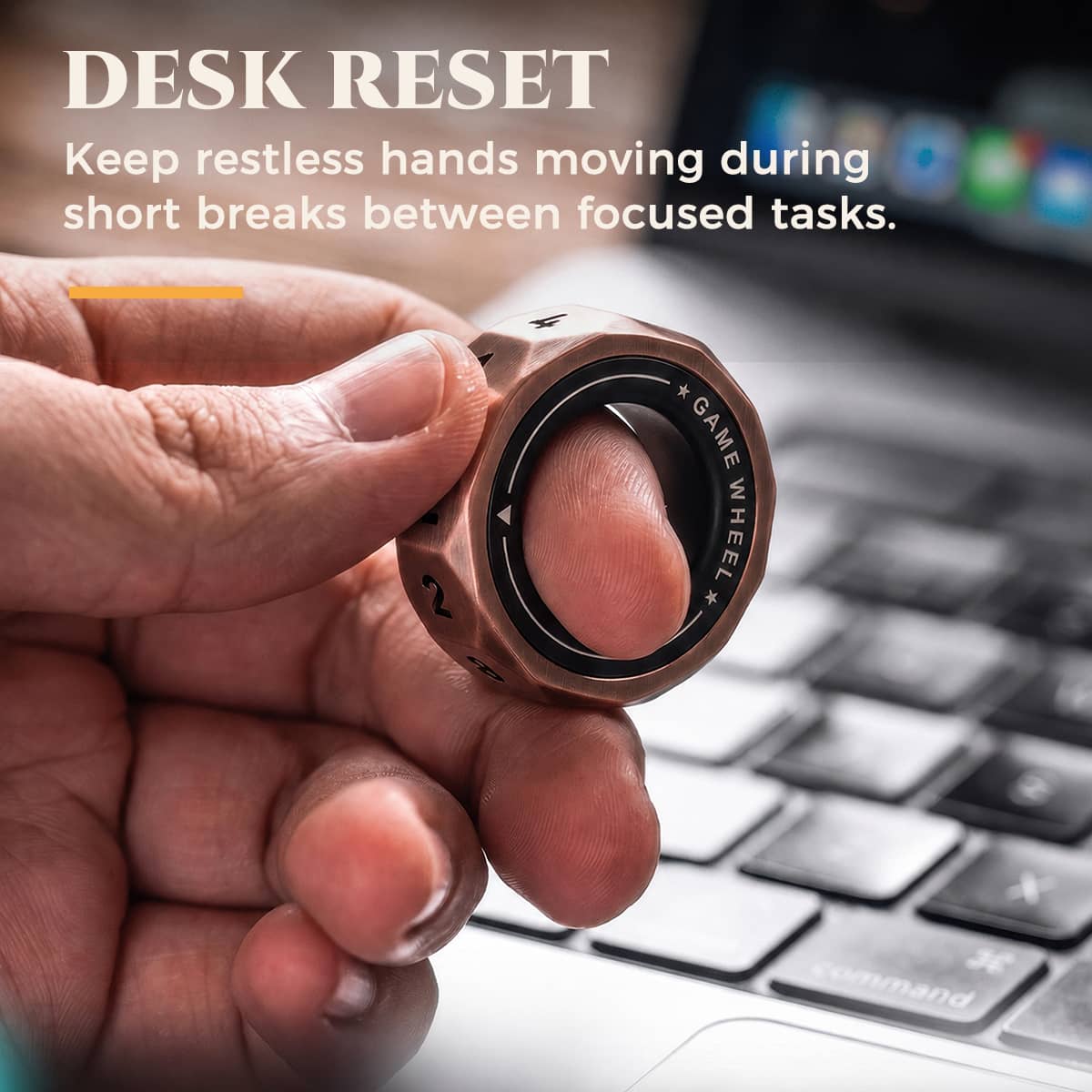 D12 magnetic decision ring used as a desk fidget beside a laptop keyboard.