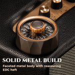 Bronze D20 roulette spinner on black leather, showing its faceted 208 g metal body.