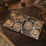 Open copper 7-in-1 dice codex with seven numbered RPG dials on a leather tabletop.