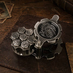Open antique silver reloadable dice cylinder with seven numbered metal dice seated inside.