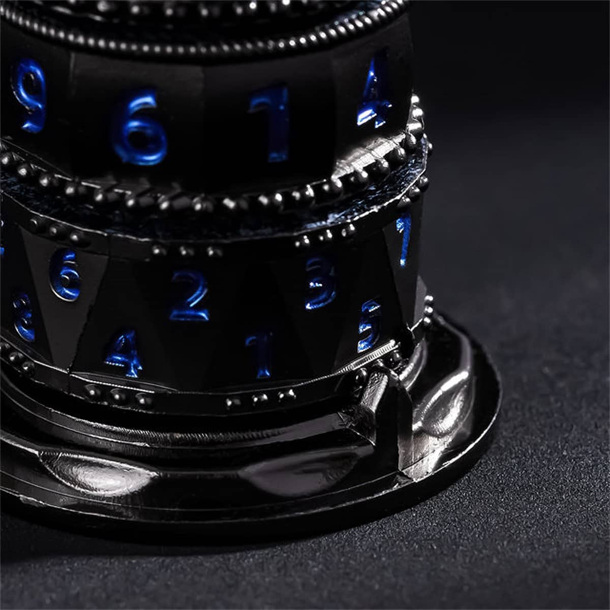 Close-up of blue-numbered metal spinner rings and the black display base.
