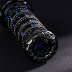 Black and blue 7-in-1 spinner dice laid horizontally with sculpted dragon end cap.