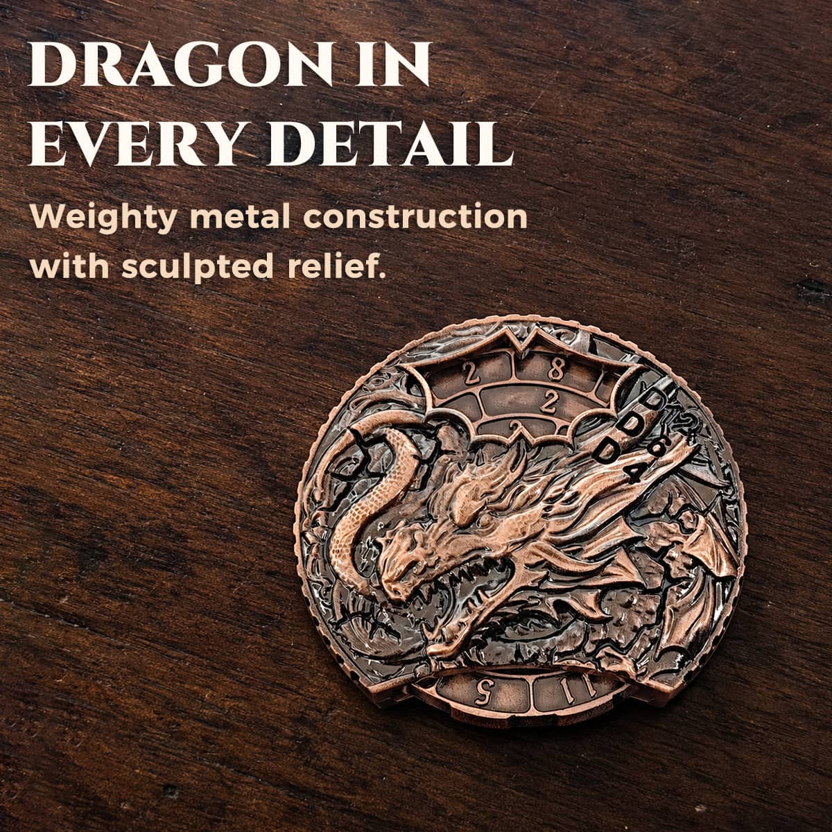 Copper 6-in-1 dice spinner with raised dragon relief displayed on a wooden tabletop.