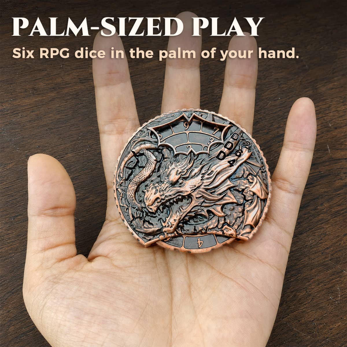 Hand holding a palm-sized silver and copper 6-in-1 dragon dice spinner.