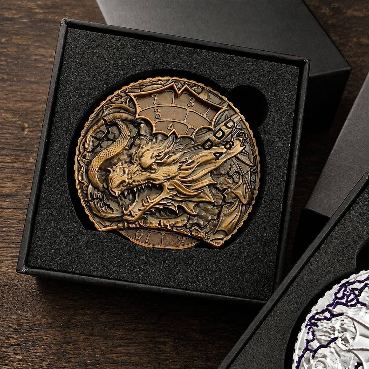 Antique gold dragon dice spinner seated inside a fitted black presentation box.