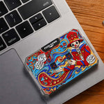Colorful joker mechanical dice card resting on the corner of a laptop.