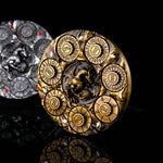 Antique gold 7-in-1 dragon dice spinner upright on a black reflective surface.