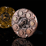 Rose gold 7-in-1 dragon dice spinner upright on a black reflective surface.