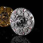Silver 7-in-1 dragon dice spinner upright on a black reflective surface.