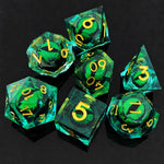 Green moving dragon eye polyhedral dice set with gold numbers on a black background.