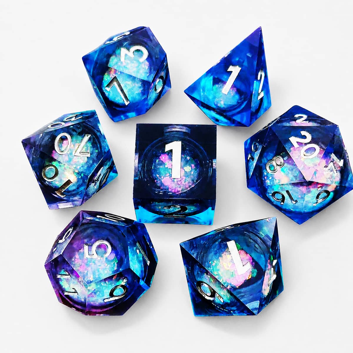 Blue and purple seven-piece liquid galaxy RPG dice set with white numbers on a white background.