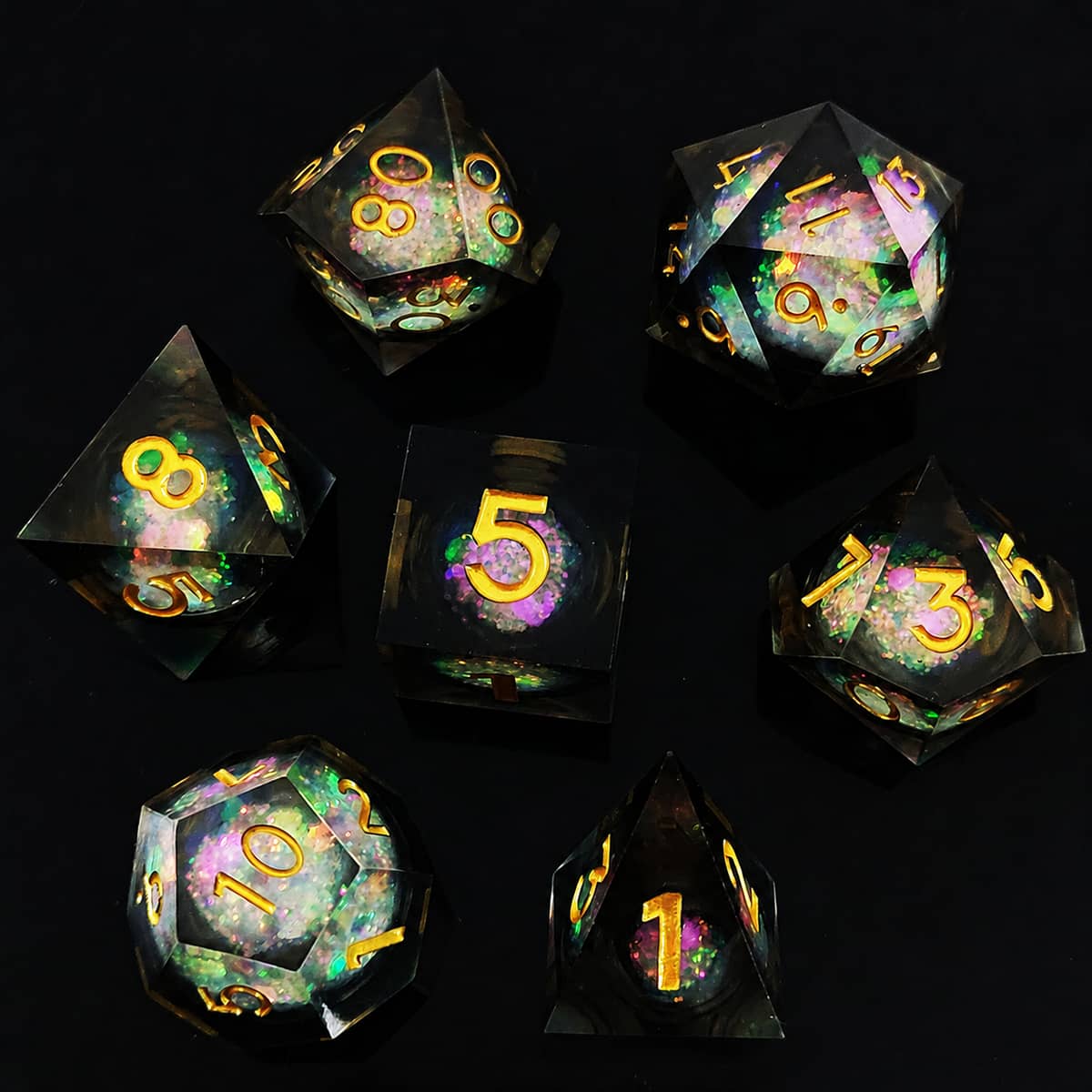 Black Gold liquid-core RPG dice set with iridescent flakes and gold numbers on black.