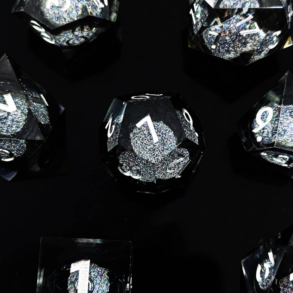 Onyx liquid-core RPG dice set with black and silver glitter and white numbers on black.