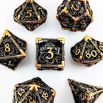 Top view of the antique gold seven-piece hollow metal RPG dice set with tentacle designs.